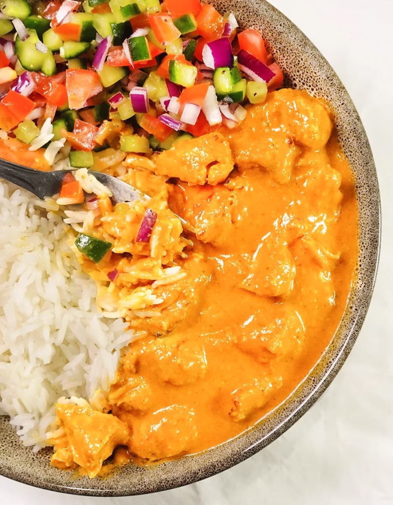 Balance meal with Homemade butter chicken is served together basmati rice , crunchy Israeli Salad